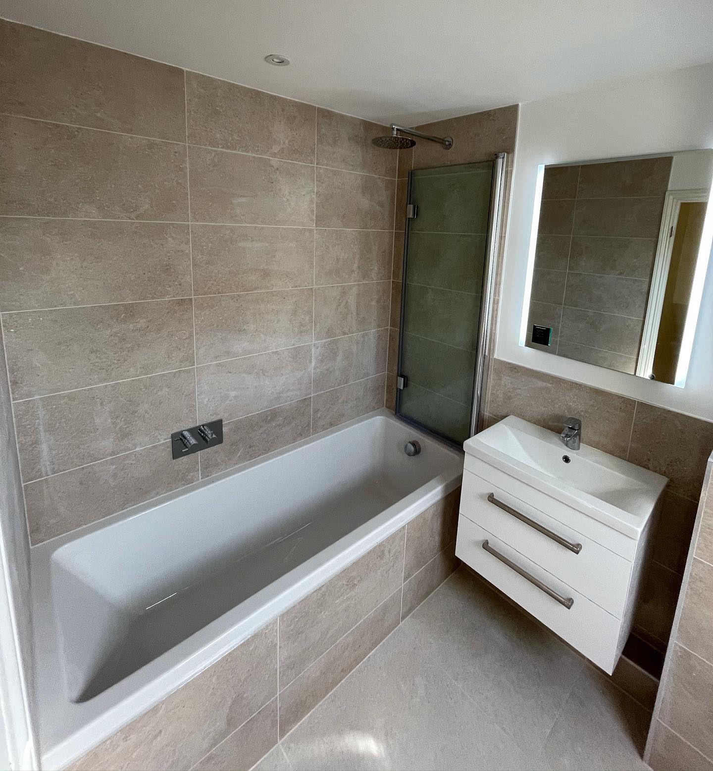 Bathroom renovation with bath and shower enclosure